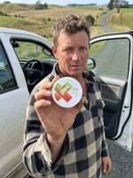 Jack W beside his ute holding a PAX Strawberry Kiwi tin