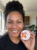 Mereoni K from Papakura holding a PAX Sweet Peach tin